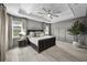 Spacious main bedroom with lake view, tray ceiling and decorative trim at 7819 Notched Pine Bnd, Wesley Chapel, FL 33545