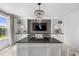Bright office space with custom built-ins, a sleek desk, and a modern chandelier at 7819 Notched Pine Bnd, Wesley Chapel, FL 33545