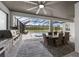 Entertain in this screened outdoor kitchen with grill, dining and beautiful pool view at 7819 Notched Pine Bnd, Wesley Chapel, FL 33545