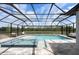 A relaxing screened pool and spa overlooks serene views of the water at 7819 Notched Pine Bnd, Wesley Chapel, FL 33545