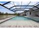 Enjoy the screened pool and spa with serene water views from the backyard at 7819 Notched Pine Bnd, Wesley Chapel, FL 33545