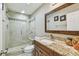 Updated bathroom featuring a glass-enclosed shower, granite countertop vanity, and modern fixtures at 8006 Tanglewood Ln, Tampa, FL 33615