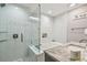 Bright bathroom featuring a glass shower, soaking tub, and marble countertop at 8006 Tanglewood Ln, Tampa, FL 33615