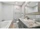 Elegant bathroom with a large mirror, vanity with marble countertop, and neutral colors at 8006 Tanglewood Ln, Tampa, FL 33615
