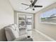 Bright bonus room with tile floors, ceiling fan, sliding glass doors and comfortable seating at 8006 Tanglewood Ln, Tampa, FL 33615