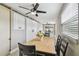 Dining area featuring barn doors, a ceiling fan, and backyard views at 8006 Tanglewood Ln, Tampa, FL 33615