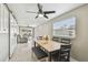 Bright dining area featuring a table with seating and sliding barn door access to living room at 8006 Tanglewood Ln, Tampa, FL 33615