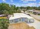 Charming single-story home with a newly painted blue exterior, white trim, and mature landscaping at 8006 Tanglewood Ln, Tampa, FL 33615