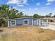 Home exterior featuring a driveway, some greenery, and a gated entry, set under a bright sky at 8006 Tanglewood Ln, Tampa, FL 33615