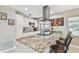 Spacious kitchen with granite island, modern vent hood, and seating at 8006 Tanglewood Ln, Tampa, FL 33615