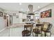 Eat-in kitchen island with barstool seating, granite countertops and pendant lighting at 8006 Tanglewood Ln, Tampa, FL 33615