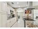 Well-lit kitchen featuring granite countertops, stainless steel appliances, and tile floors at 8006 Tanglewood Ln, Tampa, FL 33615
