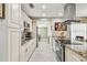 Bright kitchen features granite countertops, stainless steel appliances, and ample cabinet space at 8006 Tanglewood Ln, Tampa, FL 33615