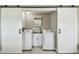 Convenient laundry room with a modern washer, dryer, sink, and cabinet offering practical functionality at 8006 Tanglewood Ln, Tampa, FL 33615