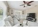 Comfortable living room with modern furniture, tile floors, and plenty of natural light at 8006 Tanglewood Ln, Tampa, FL 33615