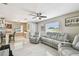 Inviting living room with tile floors, a ceiling fan, and large windows at 8006 Tanglewood Ln, Tampa, FL 33615