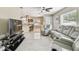 Open-concept living room with tile floors, recessed lighting, and plenty of seating at 8006 Tanglewood Ln, Tampa, FL 33615