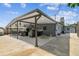 Spacious outdoor covered kitchen and entertaining area with built-in grill and bar seating at 8006 Tanglewood Ln, Tampa, FL 33615