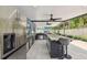 The outdoor kitchen has stainless-steel appliances, including a refrigerator and marble countertops, for perfect outdoor entertaining at 8006 Tanglewood Ln, Tampa, FL 33615