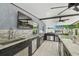 Outdoor kitchen area with stainless steel appliances, granite countertops, a sink, and a built-in grill for entertaining at 8006 Tanglewood Ln, Tampa, FL 33615