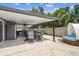 Covered patio boasts a dining table, outdoor seating, and kitchen area; it's ideal for outdoor relaxation and entertainment at 8006 Tanglewood Ln, Tampa, FL 33615