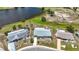 Aerial view of single-story home with pond, manicured green spaces and golf course in a well-maintained neighborhood at 904 Desert Hills Dr, Sun City Center, FL 33573