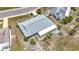 Overhead shot of the single-story home featuring a gray roof, screened porch, and minimal landscaping at 904 Desert Hills Dr, Sun City Center, FL 33573