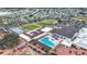 Aerial view showcasing a community recreational center with a pool and open lawn at 904 Desert Hills Dr, Sun City Center, FL 33573