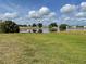 Expansive backyard with green lawn and scenic pond view at 904 Desert Hills Dr, Sun City Center, FL 33573
