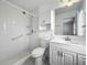 Well-lit bathroom with walk-in shower, vanity with storage, and classic white fixtures at 904 Desert Hills Dr, Sun City Center, FL 33573