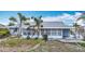 Charming single-story home with a screened-in lanai and palm trees, ready for landscaping at 904 Desert Hills Dr, Sun City Center, FL 33573