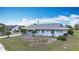 Charming single-story home with a well-maintained lawn and a bright blue sky at 904 Desert Hills Dr, Sun City Center, FL 33573