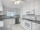 Clean kitchen with white cabinets, stainless steel dishwasher, and tile backsplash at 904 Desert Hills Dr, Sun City Center, FL 33573
