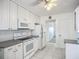 Efficient kitchen featuring white cabinets, tile floor, and stainless steel appliances at 904 Desert Hills Dr, Sun City Center, FL 33573