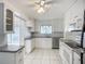 Bright kitchen featuring white cabinetry, stainless steel appliances, tile backsplash, and tile flooring at 904 Desert Hills Dr, Sun City Center, FL 33573
