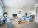 Bright living room featuring cozy seating, ceiling fan, and beach-themed decor for a relaxed ambiance at 904 Desert Hills Dr, Sun City Center, FL 33573