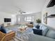 Cozy living room with light blue sofa and chairs, a woven coffee table, and a seaside view at 904 Desert Hills Dr, Sun City Center, FL 33573