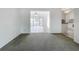 Spacious carpeted living room leads to sunroom and kitchen at 904 Desert Hills Dr, Sun City Center, FL 33573