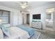 Main bedroom with ensuite bathroom, spacious closet, and blue accents at 904 Desert Hills Dr, Sun City Center, FL 33573