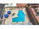 Aerial view of outdoor pool with lounge chairs and umbrellas at a community center or resort at 904 Desert Hills Dr, Sun City Center, FL 33573