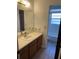 Bathroom with sink, vanity, and a mirror, providing essential amenities at 531 Carriage Hills Dr, Temple Terrace, FL 33617