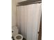 Compact bathroom featuring a standard toilet and a shower/tub combo with a white curtain at 531 Carriage Hills Dr, Temple Terrace, FL 33617