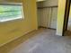 Cozy bedroom featuring a window with natural light and built-in closet with sliding doors at 531 Carriage Hills Dr, Temple Terrace, FL 33617