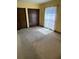 Bright bedroom featuring natural light from a window and a double sliding door closet at 531 Carriage Hills Dr, Temple Terrace, FL 33617