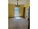 Well-lit dining room featuring a classic chandelier and a large window for natural light at 531 Carriage Hills Dr, Temple Terrace, FL 33617