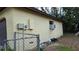 The exterior of the home shows a fenced in area and a window air conditioning unit at 531 Carriage Hills Dr, Temple Terrace, FL 33617