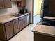 Efficient kitchen with stainless steel appliances, wood-look cabinets, and an adjacent dining area at 531 Carriage Hills Dr, Temple Terrace, FL 33617