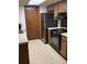 Functional kitchen with stainless steel appliances, wooden cabinets, and ample counter space at 531 Carriage Hills Dr, Temple Terrace, FL 33617