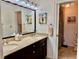 Bathroom featuring double sinks, granite countertops, and a shower with tan tile at 100 Bluff View Dr # 105C, Belleair Bluffs, FL 33770