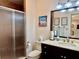 Bathroom featuring a glass shower and dark wood vanity with a neutral countertop at 100 Bluff View Dr # 105C, Belleair Bluffs, FL 33770